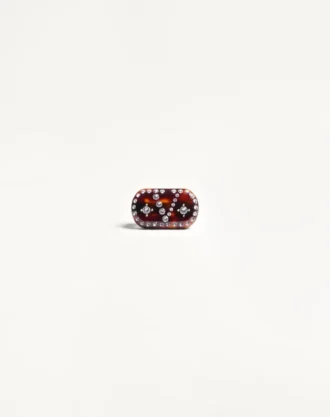 Vlogo Signature hårspenne i harpiks, metall og krystaller